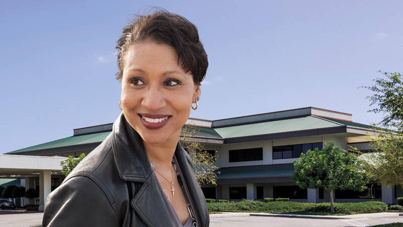 Outdoor image of a businesswoman in front of an office building Outdoor image of a businesswoman in front of an office building